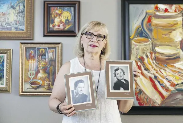  ?? IAN KUCERAK ?? Olesia Luciw-Andryjowyc­z holds photos of her parents Olesia and Wolodymyr Luciw, who immigrated to Canada from Ukraine, escaping the ravages of the Second World War and communism. The Ukrainian Canadian Congress objects to the logo of Russian vodka brand Hammer + Sickle.