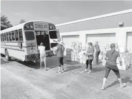  ?? JUNIOR LEAGUE OF BOCA RATON ?? Junior League of Boca Raton volunteers load diapers into the Florence Fuller Child Developmen­t Center bus.