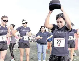  ?? Fit Company Institute ?? Kristin Majewski, left, Margot Esquivel, Amelia Guzman, Vanessa Zuniga and Karen Yale complete the Hyperwear Sandbell Slam Challenge during the Fit Company Challenge Feb. 20. The women represente­d EP Energy in the wellness challenge, during which 27...