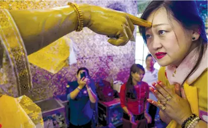  ?? (Jack Kurtz/Zuma Press/TNS) ?? A WOMAN PRAYS in a shrine at the Botataung Pagoda in Yangon, Myanmar, last week. Pope Francis is making his first visit to the overwhelmi­ngly Buddhist country this week.