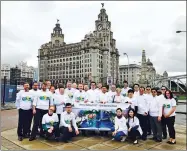  ?? PROVIDED TO CHINA DAILY ?? Staff at Henry Bath in Liverpool show their support for the Belt and Road Initiative.