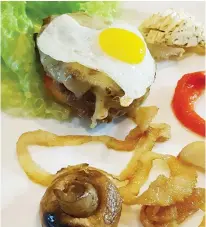  ??  ?? BARE BEEF BURGER Café de Paris. Slather Café de Paris butter over a miniature prime beef burger topped with melted cheddar cheese as the runny yolk of a quail egg drips down its side. Nearly carbfree, you will be able to afford the skinny...