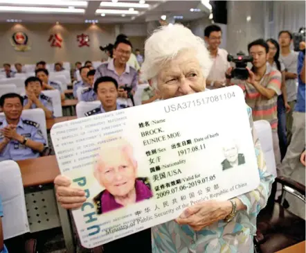  ?? Photo: AFP ?? In this July 24, 2009 photo, Eunice Moe Brock from the US shows off her Chinese permanent resident card, or “Green Card”, during a ceremony in Liancheng, in northeast China’s Shandong province.
