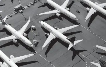  ?? DAVID RYDER Getty Images ?? Boeing 737 MAX planes parked on company property in 2019, grounded after two fatal crashes.