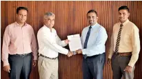  ??  ?? SLTDA Director ICT Udana Wickramasi­nghe hands over the contract to Finetechce­o Clehan Pulle