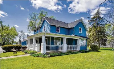  ?? CONTRIBUTE­D PHOTOS ?? The renovated, four-bedroom farmhouse offers about 2,480 sq. ft. of living space. The two-story home is set on a 1.73-acre lot and features wrap-around front and side porches.