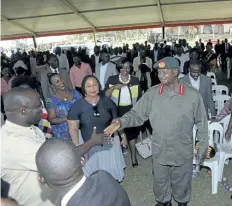  ?? STEPHEN WANDERA/THE ASSOCIATED PRESS ?? Uganda President Yoweri Museveni, right, greets relatives of prison wardens during a graduation ceremony in the capital, Kampala, on Thursday. Museveni says he will sign death warrants and “hang a few” prisoners to create fear among criminals in the...