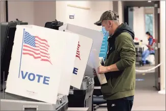  ?? Win McNamee / TNS ?? Virginia residents vote at the Fairfax County Government Center on Tuesday in Fairfax, Va. Virginia and New Jersey held off-year elections Tuesday in the first major elections since U.S. President Joe Biden’s victory in 2020.