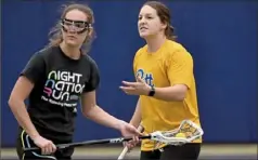  ?? Matt Freed/Post-Gazette ?? Pitt lacrosse recruit Emily Coughlin of Oakland Catholic works out during a skills session next to head coach Emily Boissonnea­ult Jan. 22 at Cost Sports Center.