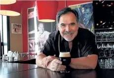  ?? LAURA BARTON/POSTMEDIA NETWORK ?? Fred Davies, owner of San Marco’s Ristorante in Port Colborne, is set to open a brewery in that city’s downtown called Breakwall Taphouse and Brewery. He is pictured here in San Marco’s with one of the beers currently served at that restaurant in...