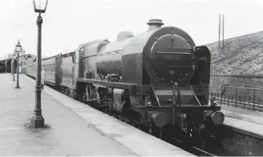  ??  ?? After their introducti­on in 1930 the so-called ‘Baby Scots’ quickly became establishe­d on the ‘Little North Western’ lines, replacing the ex-L&NWR ‘Claughton’ class 4-6-0s that inspired them. These Fowler 4-6-0s were quickly found at work on the ‘Thames-Clyde’ and ‘Thames-Forth’ expresses, as well as the Heysham boat trains, but on 26 September 1936 we find No 5547 of Newton Heath shed in the up bay platform at Hellifield waiting departure time with an express working to Manchester over the ex-L&YR line through Blackburn. In Midland days these workings were the preserve of the MR and L&YR 4-4-0s, and later LMS days saw 2-6-2Ts and 2-6-4Ts employed. The un-named No 5547 is still quite new, having emerged from Crewe Works in April 1934. Considered a ‘Patriot’ postFebrua­ry 1937, the pictured locomotive would remain in traffic until September 1962.