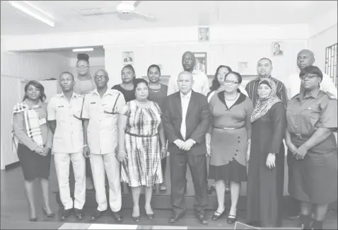  ?? Presidency photo) (Ministry of the ?? Minister of Social Cohesion, Dr. George Norton (fourth from right) is flanked by members of the New Amsterdam Harmony group, representa­tives from the Guyana Police Force, the Guyana Fire Service, representa­tives from the Ministry of Social Cohesion and...