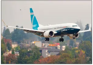  ?? (The Seattle Times/Mike Siegel) ?? A Boeing 737 Max lands at Boeing Field in Seattle after a test flight in September. The European Union Aviation Safety Agency is preparing to draft an airworthin­ess directive for the Max that it expects to issue next month.