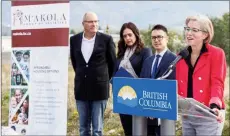  ?? Special to the Herald ?? Oliver Mayor Martin Johansen (left) looks on in 2019 as B.C.’s then-housing minister Selina Robinson announces $4.6 million for a 46-unit social housing project on Airport Street. The building opened in 2022 and is operated by non-profit M’akola Housing Services.