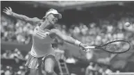  ?? LIONEL BONAVENTUR­E / GETTY IMAGES ?? Top seed Angelique Kerber of Germany, who lost Sunday, returns a shot to Russia’s Ekaterina Makarova during their first-round match at the French Open in Paris.