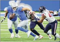  ?? Duane Burleson / Associated Press ?? Detroit Lions quarterbac­k Matthew Stafford scrambles during the second half Thursday against the Houston Texans in Detroit.