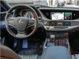  ?? Lexus photo ?? The LS dashboard features new, laser-cut wood veneers that expose a sweeping wave of bright metal lines that flow horizontal­ly.