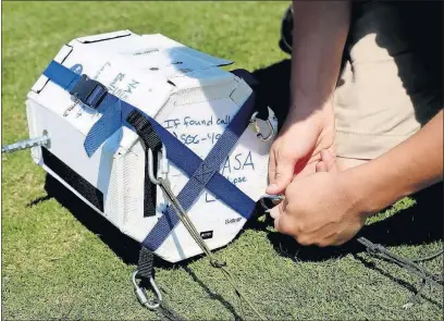  ??  ?? A payload is readied for launch and attached to the space balloon shortly before the solar eclipse became apparent in Kentucky.