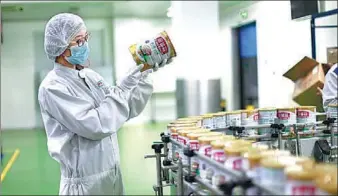  ?? PROVIDED TO CHINA DAILY ?? A worker inspects dairy products at a production line of Yili Industrial Group Co in Hohhot, capital of the Inner Mongolia autonomous