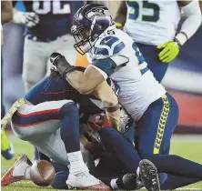  ?? STAFF PHOTO BY MATT WEST ?? GETTING AWAY FROM THEM: Julian Edelman fumbles in the fourth quarter, which proved costly to the Patriots in their 31-24 loss to the Seahawks last night.