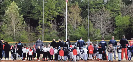  ?? / contribute­d by Gail conner ?? Teams lined up to honor the flag during the playing of the National Anthem during Cedartown’s Little League opening day ceremonies on March 16.