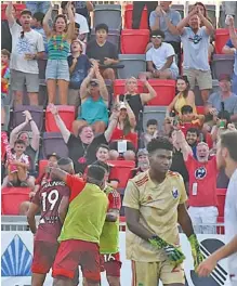  ?? STAFF PHOTO BY MATT HAMILTON ?? Teammates and fans celebrate after a score by the Chattanoog­a Red Wolves’ Juan Galindrez (19) on June 20 at CHI Memorial Stadium.