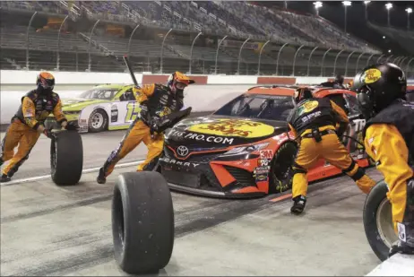  ?? AP PHOTO/BRYNN ANDERSON ?? Martin Truex Jr. makes a pit stop during the NASCAR Cup Series auto race Wednesday in Darlington, S.C.