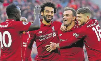  ?? AP ?? Erstes Liga-tor für Liverpool: Xherdan Shaqiri (2. v. r.) lässt sich von seinen Teamkolleg­en feiern.