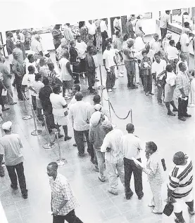  ?? FILE ?? Taxpayers queue to conduct business at a tax collectora­te in Kingston.