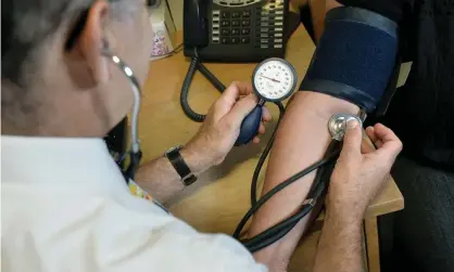  ??  ?? A GP checks a patient’s blood pressure. Photograph: Anthony Devlin/PA