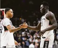  ?? Jessica Hill / Associated Press ?? UConn's Jordan Hawkins and Adama Sanogo shake hands at the end of Thursday's win over Oklahoma State.