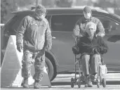  ?? ROBERTF. BUKATY/AP ?? National Guardsmen help a patient at a COVID-19 vaccinatio­n site Friday in Augusta, Maine.