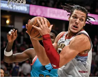  ?? AARON ONTIVEROZ — THE DENVER POST ?? Aaron Gordon (50) of the Denver Nuggets grabs a rebound away from Deandre Ayton (22) of the Phoenix Suns during the fourth quarter of Denver’s 128-125win at Ball Arena in Denver on Sunday, December 25, 2022.
