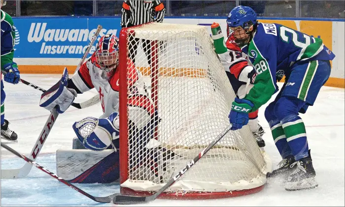  ?? STEVEN MAH/SOUTHWEST BOOSTER ?? Swift Current Broncos defenseman Sam Mcginley (right) nearly scored on a wraparound attempt against Lethbridge’s Bryan Thomson on Saturday.