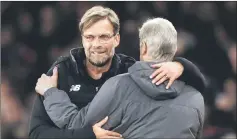  ??  ?? Klopp and Arsene Wenger embrace after the match. — AFP photo