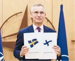  ?? JOHANNA GERON/POOL PHOTO VIA AP ?? NATO Secretary-General Jens Stoltenber­g displays documents as Sweden and Finland applied for membership Wednesday in Brussels, Belgium.