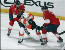  ?? JOEL AUERBACH — THE ASSOCIATED PRESS ?? Florida’s Keith Yandle (3) and Aaron Ekblad (5) defend against Flyers center Nolan Patrick (19) during the third period Thursday in Sunrise, Fla.