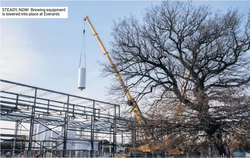  ??  ?? STEADY, NOW! Brewing equipment is lowered into place at Everards