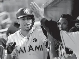  ?? LYNNE SLADKY/AP PHOTO ?? Giancarlo Stanton of the Marlins is congratula­ted in the dugout after hitting a two-run home run in the eighth inning of Wednesday’s game against the Mets at Miami.