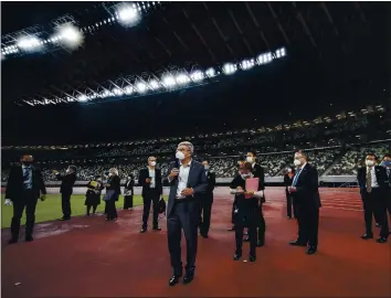  ?? BEHROUZ MEHRI — GETTY IMAGES ?? IOC president Thomas Bach, center, is adamant that the Tokyo Summer Games will be held this year. Here he is touring the National Stadium, main venue for the postponed Games, in November in Tokyo.