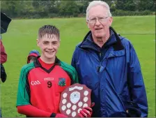  ??  ?? Owen Doyle presents the shield to captain Sam Reid.