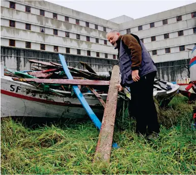  ?? Photos: AP ?? Opera maximum security prison inmate Andrea Volonghi checks scrapwood stored at the facility, near the Italian city of Milan.