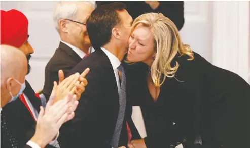  ?? Blair Gable / REUTERS ?? Mona Fortier, Minister of Middle Class Prosperity and Associate Minister of Finance, is embraced by Finance Minister Bill Morneau during the swearing in of Prime Minister Justin Trudeau’s new cabinet on Thursday.