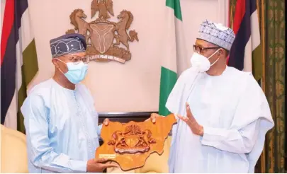  ??  ?? President Muhammadu Buhari presents a parting gift to the outgoing Special Representa­tive of the United Nations Secretary General for West Africa and Sahel, Dr Mohamed Ibn Chambas during a farewell audience at the presidenti­al villa Abuja yesterday. Photo: Felix Onigbinde