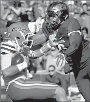  ?? NWA Democrat-Gazette file photo ?? Arkansas Razorbacks junior Randy Ramsey (right) tackles Florida quarterbac­k Luke Del Rio during a game last season. Ramsey, one of the most experience­d outside linebacker returning this season, is seeing time at multiple positions.