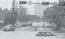  ?? Michael Ciaglo / Houston Chronicle ?? A car sits stranded in high water at Studemont and Allen Parkway after Buffalo Bayou overflowed its banks last month.