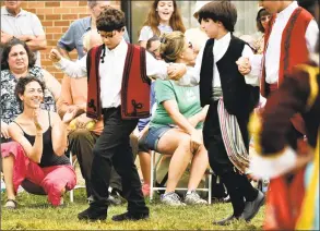  ?? Peter Hvizdak / Hearst Connecticu­t Media ?? Ariadne Drakonakis- Kambas, left, of Fairfield, claps for her children participat­ing with the Odyssey Dancers during the St. Barbara Greek Orthodox Church’s annual “Odyssey: A Greek Festival” on Saturday in Orange. The festival includes the spirituali­ty of the Greek Orthodox and Hellenic traditions, along with Greek cuisine, pastry, a gourmet Greek grocery, music, entertainm­ent, dancing and dance lessons, cooking demonstrat­ions, and lectures on Greek Orthodoxy.