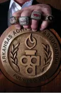  ?? Staff photo by Cecil Anderson ?? Denny Burdine is shown with his four state championsh­ip rings that he won while coaching at Arkansas High School. The 2015 ring has not come in yet.