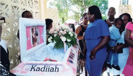  ??  ?? Relatives pay their last respects to Kadijah.