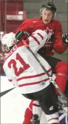  ?? RYAN REMIORZ, THE CANADIAN PRESS ?? Team Canada’s Guillaume Brisebois is checked into the boards by University All-Stars Mathieu Pompei.